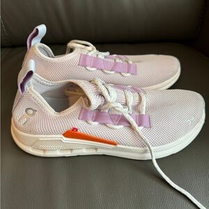 On Running Cloud Sneakers in Light Lavender with Orange Accent.